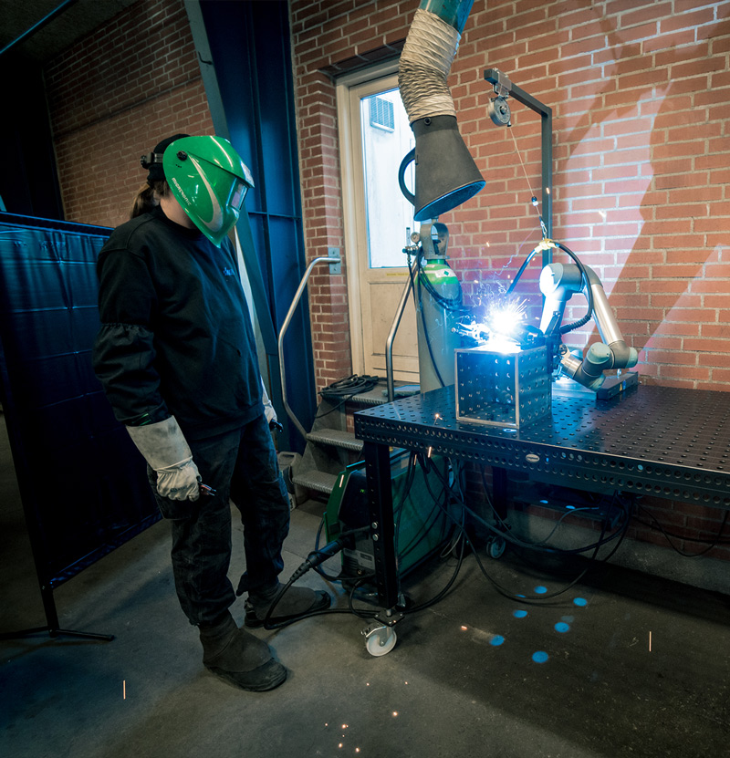 Welder watching the cowelder work